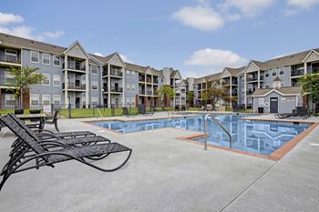 our apartments feature a swimming pool with an apartment building in the background